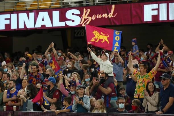 Lions fans cheer after the win of the round 23 AFL match between Brisbane Lions and West Coast Eagles at The Gabba on August 21, 2021 in Brisbane,...