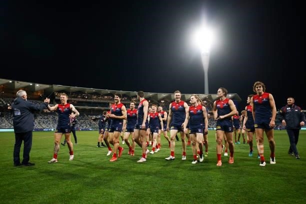 The Demons leave the field celebrating after winning the round 23 AFL match between Geelong Cats and Melbourne Demons at GMHBA Stadium on August 21,...