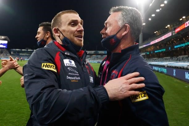 Demons head coach Simon Goodwin is embraced by Demons assistant coach Alan Richardson during the round 23 AFL match between Geelong Cats and...