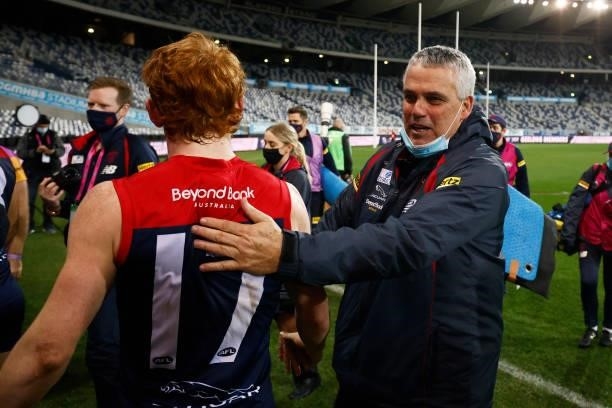 Demons assistant coach Mark Williams celebrates with players after the round 23 AFL match between Geelong Cats and Melbourne Demons at GMHBA Stadium...