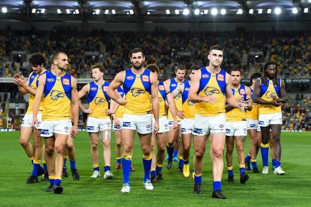 The West Coast Eagles walk off the field after their defeat during the round 23 AFL match between the Brisbane Lions and the West Coast Eagles at The...