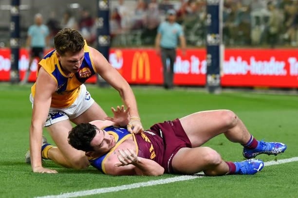 Lachie Neale of the Lions and Alex Witherden of the Eagles clash during the round 23 AFL match between the Brisbane Lions and the West Coast Eagles...