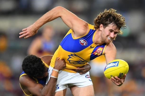 Connor West of the Eagles is tackled by Keidean Coleman of the Lions during the round 23 AFL match between the Brisbane Lions and the West Coast...