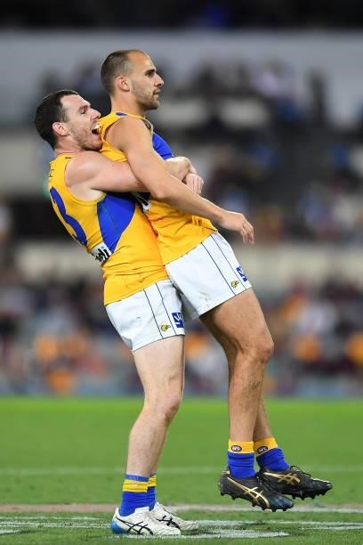 Luke Shuey of the Eagles picks up team mate Dom Sheed to celebrate after Dom Sheed kicked towards goal but missed during the round 23 AFL match...