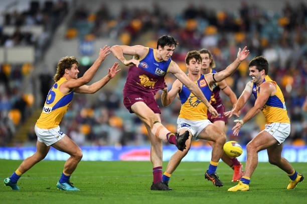 Oscar McInerney of the Lions kicks the ball under pressure during the round 23 AFL match between the Brisbane Lions and the West Coast Eagles at The...