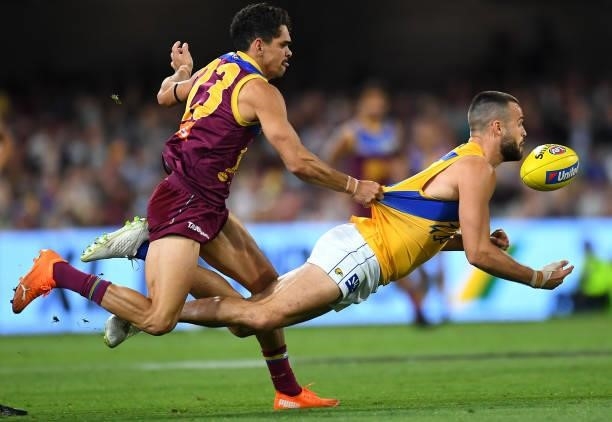 Josh Rotham of the Eagles is tackled by Charlie Cameron of the Lions during the round 23 AFL match between the Brisbane Lions and the West Coast...
