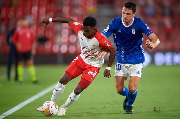 Largie Ramazani of UD Almeria competes for the ball with Borja Sanchez Laborde of Real Oviedo during the LaLiga Smartbank match between UD Almería...