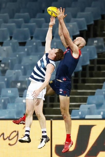 Max Gawn of the Demons marks the ball against Gary Rohan of the Cats moments before the final siren during the round 23 AFL match between Geelong...