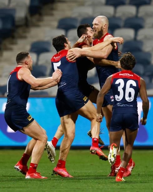 The Demons celebrate a goal to Max Gawn of the Demons after the siren to win the round 23 AFL match between Geelong Cats and Melbourne Demons at...