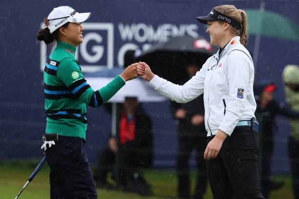 Minjee Lee of Australia and Brooke Henderson of Canada bump fists on the eighteenth green during Day Three of the AIG Women's Open at Carnoustie Golf...