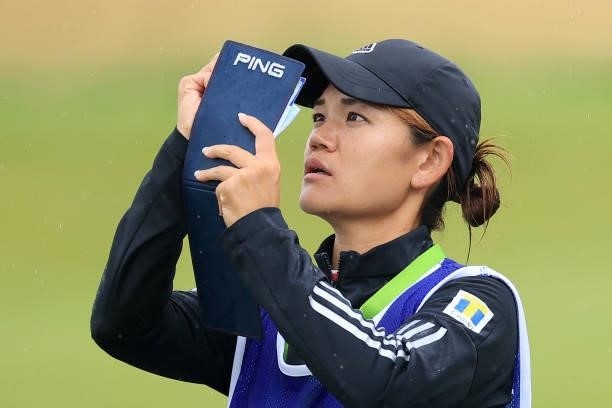 The caddie of Hinako Shibuno of Japan looks at the pocket book on the eighteenth fairway during Day Three of the AIG Women's Open at Carnoustie Golf...