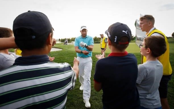 Dean Burmester of South Africa with young fans on the 18th hole during Day Three of The D+D Real Czech Masters at Albatross Golf Resort on August 21,...