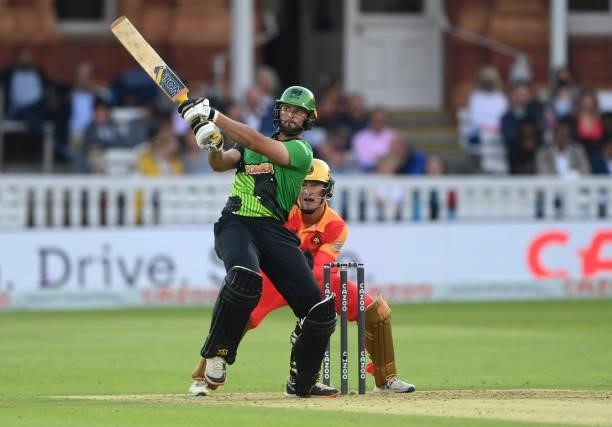 Brave batsman Ross Whiteley hits out watched by Phoenix keeper Chris Benjamin during The Hundred Final match between Birmingham Phoenix Men and...