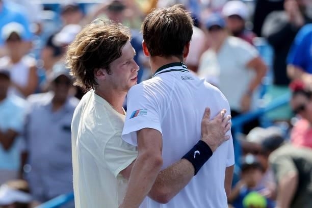 Andrey Rublev of Russia and Daniil Medvedev of Russia meet after Rublev won their match 2-6, 6-3, 6-3 during day 7 of the Western & Southern Open at...