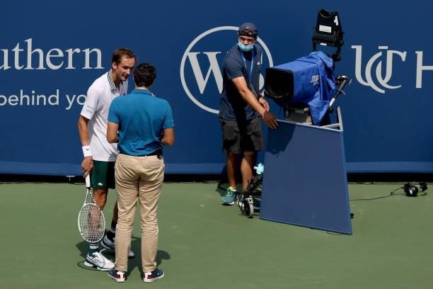 Daniil Medvedev of Russia speaks to chair umpire Nacho Forcadell after colliding with a television camera in his match against Andrey Rublev of...