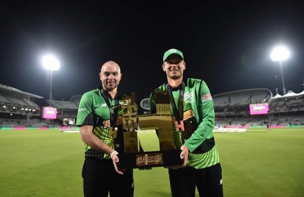 Jake Lintott and Danny Briggs of Southern Brave Men poses with The Men's Hundred Trophy following The Hundred Final match between Birmingham Phoenix...