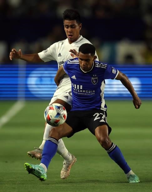 Efrain Alvarez of Los Angeles Galaxy and Marcos Lopez of San Jose Earthquakes in the first half at Dignity Health Sports Park on August 20, 2021 in...