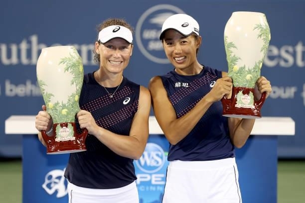 Samantha Stosur of Australia and Shuai Zhang of China pose with the winner's trophy after defeating Gabriela Dabrowski of Canada and Luisa Stefani of...