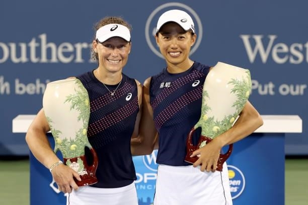 Samantha Stosur of Australia and Shuai Zhang of China pose with the winner's trophy after defeating Gabriela Dabrowski of Canada and Luisa Stefani of...
