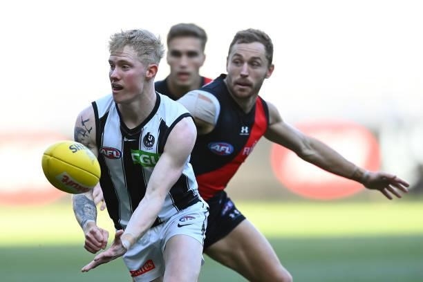John Noble of the Magpies handballs during the round 23 AFL match between Essendon Bombers and Collingwood Magpies Giants at Melbourne Cricket Ground...
