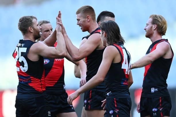 Peter Wright of the Bombers is congratulated by his teammates during the round 23 AFL match between Essendon Bombers and Collingwood Magpies Giants...