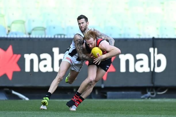 Aaron Francis of the Bombers is tackled by Jeremy Howe of the Magpies during the round 23 AFL match between Essendon Bombers and Collingwood Magpies...