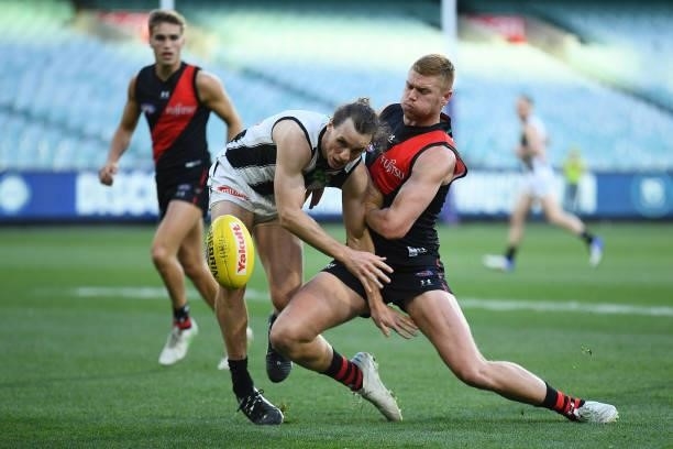Chris Mayne of the Magpies is tackled by Peter Wright of the Bombers during the round 23 AFL match between Essendon Bombers and Collingwood Magpies...