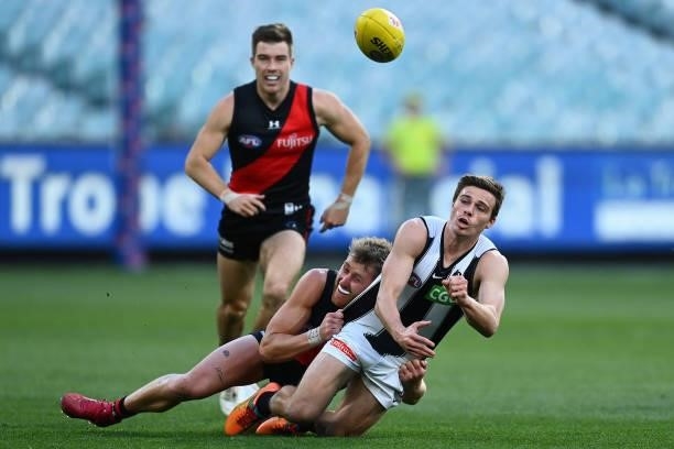 Josh Thomas of the Magpies is tackled by Dyson Heppell of the Bombers during the round 23 AFL match between Essendon Bombers and Collingwood Magpies...