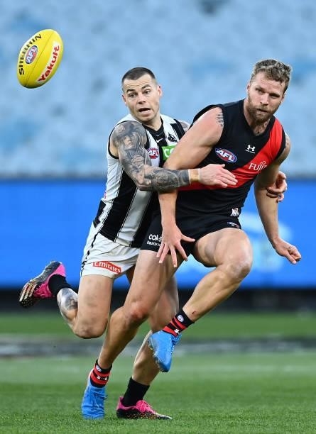 Jake Stringer of the Bombers is tackled by Jamie Elliott of the Magpies during the round 23 AFL match between Essendon Bombers and Collingwood...