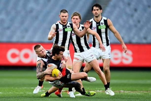 Andrew McGrath of the Bombers is tackled during the round 23 AFL match between Essendon Bombers and Collingwood Magpies at Melbourne Cricket Ground...
