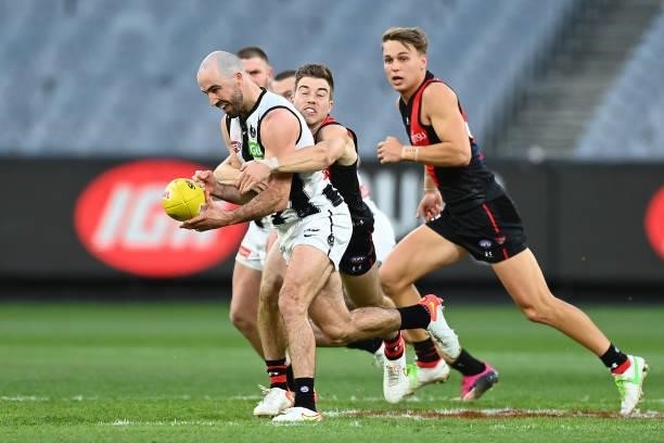 Steele Sidebottom of the Magpies is tackled during the round 23 AFL match between Essendon Bombers and Collingwood Magpies at Melbourne Cricket...