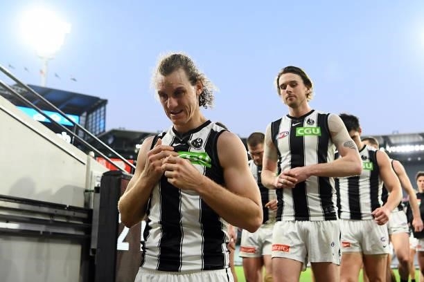 Chris Mayne of the Magpies leaves the field after his last game following the round 23 AFL match between Essendon Bombers and Collingwood Magpies at...