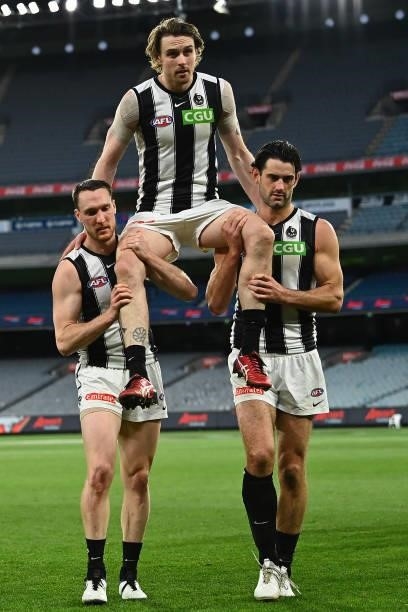 Jordan Roughead of the Magpies is chaired off after his 200th game in the round 23 AFL match between Essendon Bombers and Collingwood Magpies at...
