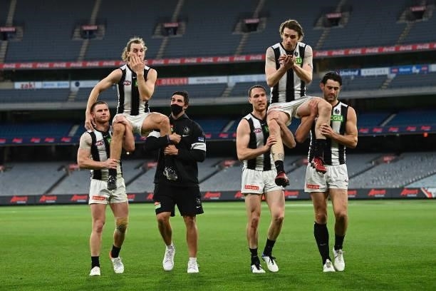 Chris Mayne of the Magpies is chaired from the field after his last game and Jordan Roughead of the Magpies is chaired off after his 200th game in...