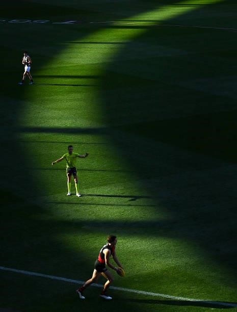Jordan Ridley of the Bombers kicks in from the boundary line during the round 23 AFL match between Essendon Bombers and Collingwood Magpies Giants at...