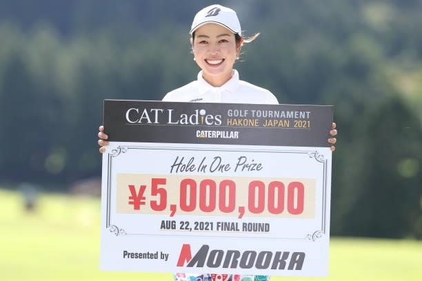 Yukari Nishiyama of Japan poses with her prize after making a hole in one on the 17th hole during the final round of the CAT Ladies at Daihakone...