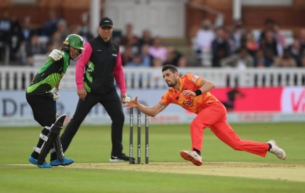 Phoenix bowler Benny Howell fields off his own bowling during The Hundred Final match between Birmingham Phoenix Men and Southern Brave Men at Lord's...