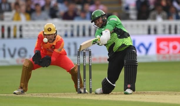 Brave batsman Paul Stirling hits out watched by Phoenix keeper Chris Benjamin during The Hundred Final match between Birmingham Phoenix Men and...