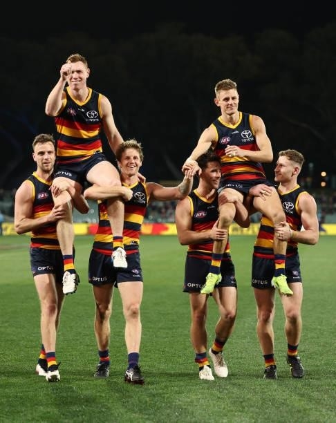Tom Lynch of the Crows and David Mackay of the Crows are chaired off the ground during the round 23 AFL match between Adelaide Crows and North...