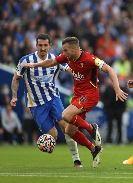 Tom Cleverley of Watford and Lewis Dunk of Brighton & Hove Albion in action during the Premier League match between Brighton & Hove Albion and...