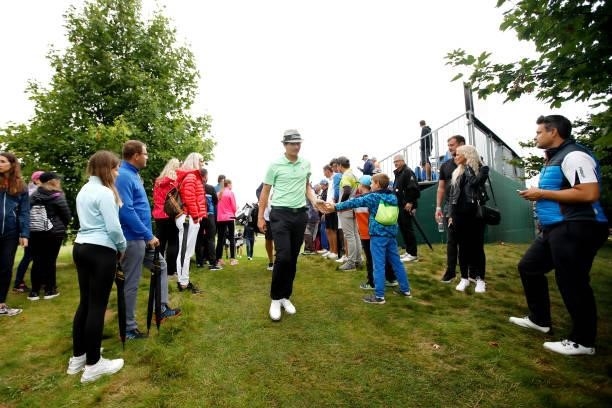 Tapio Pulkkanen of Finland interacts with fans as he makes his way from the ninth hole during Day Four of The D+D Real Czech Masters at Albatross...