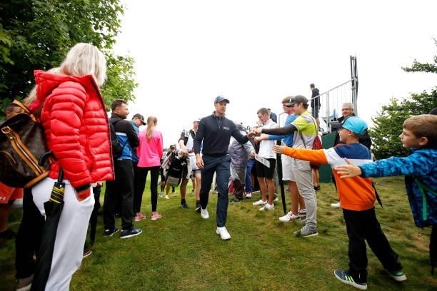 Henrik Stenson of Sweden interacts with fans as he makes his way from the ninth hole during Day Four of The D+D Real Czech Masters at Albatross Golf...