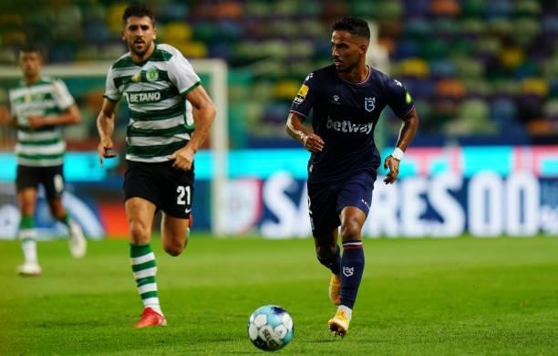 Diogo Calila of Belenenses SAD with Paulinho of Sporting CP in action during the Liga Bwin match between Sporting CP and Belenenses SAD at Estadio...