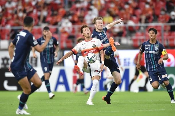 Yoichiro KAKITANI of Nagoya Grampus and DOUGLAS GROLLI of Avispa Fukuoka battle for the ball during the J.League Meiji Yasuda J1 match between Nagoya...