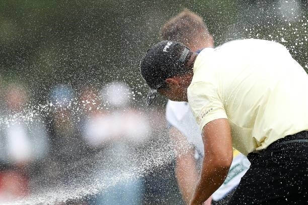 Johannes Veerman of United States is showered in champagne as he celebrates on the 18th hole after winning the D+D Real Czech Masters during Day Four...