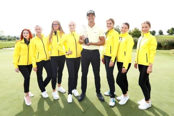Johannes Veerman of United States poses with the trophy after winning the D+D Real Czech Masters alongside staff members of Raiffeisen Bank during...