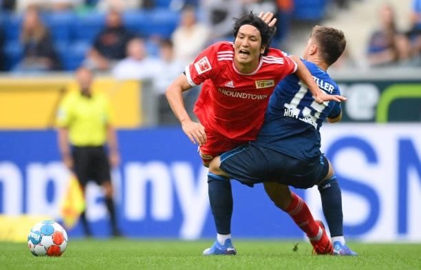 Genki Haraguchi of 1.FC Union Berlin is challenged by Angelo Stiller of TSG 1899 Hoffenheim during the Bundesliga match between TSG Hoffenheim and 1....