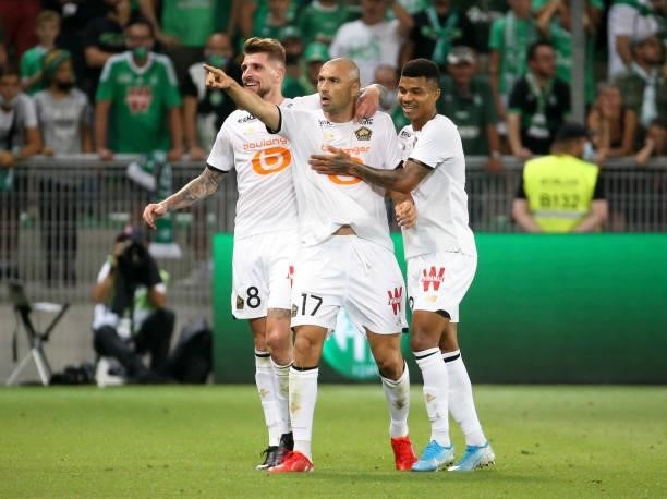 Burak Yilmaz of Lille celebrates his goal with Xeka, Reinildo Mandava during the Ligue 1 match between AS Saint Etienne and Lille OSC at Stade...