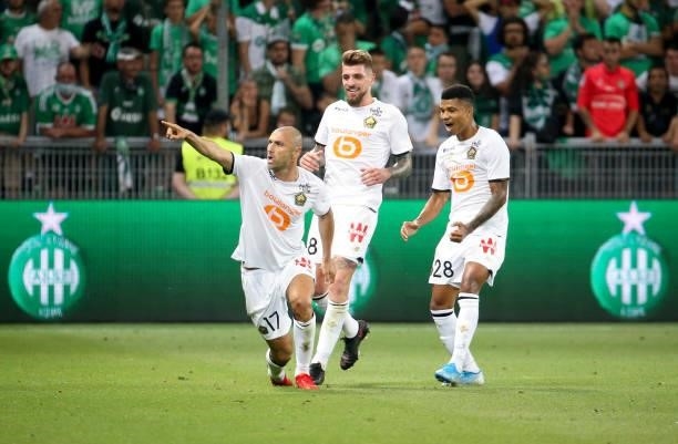 Burak Yilmaz of Lille celebrates his goal with Xeka, Reinildo Mandava during the Ligue 1 match between AS Saint Etienne and Lille OSC at Stade...