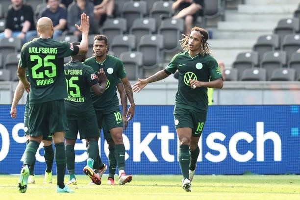 Lukas Nmecha of VfL Wolfsburg celebrates with team mates after scoring their side's second goal during the Bundesliga match between Hertha BSC and...